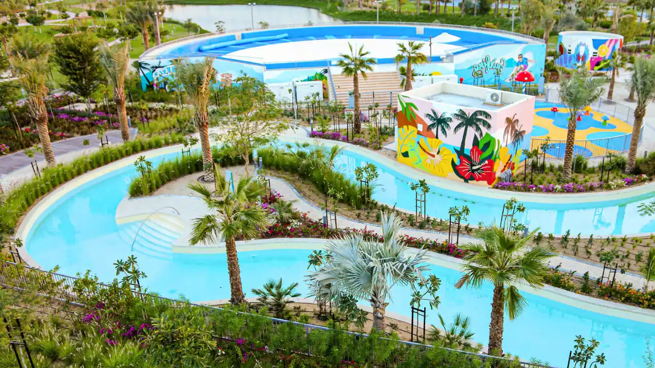 Natura at DAMAC Hills 2 by DAMAC Properties Water Town featuring lazy river landscaped gardens palm trees and family friendly water attractions in Dubai Presented by Tohid Fetrat