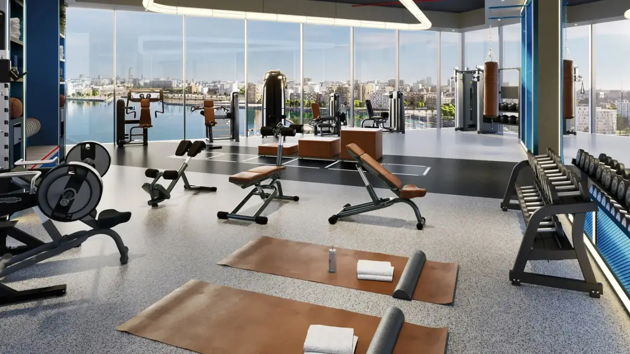 Nautica Two by Select Group in Dubai Maritime City modern fitness center with strength training equipment panoramic waterfront views and contemporary interiors in Dubai Presented by Tohid Fetrat