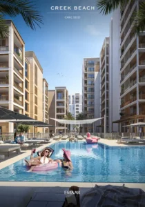 Orchid at Dubai Creek Harbour by Emaar Properties resort style swimming pool with sun loungers and contemporary apartment buildings in Dubai Presented by Tohid Fetrat