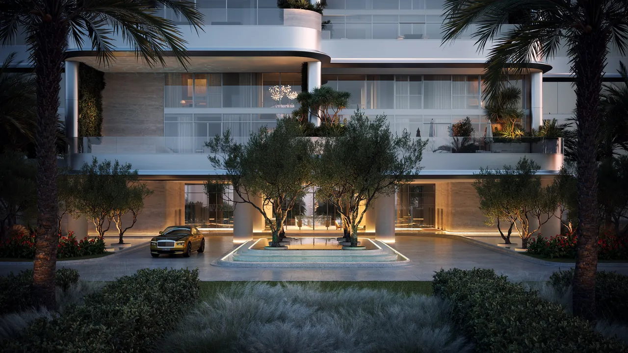 ORLA Infinity Dorchester Collection by Omniyat arrival driveway at dusk with reflecting pool mature olive trees illuminated travertine columns and covered porte cochere in Dubai - Presented by Tohid Fetrat