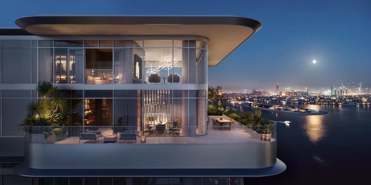 ORLA Infinity Dorchester Collection by Omniyat signature penthouse terrace illuminated at night with outdoor lounge dining area and Dubai Marina skyline across the water in Dubai - Presented by Tohid Fetrat