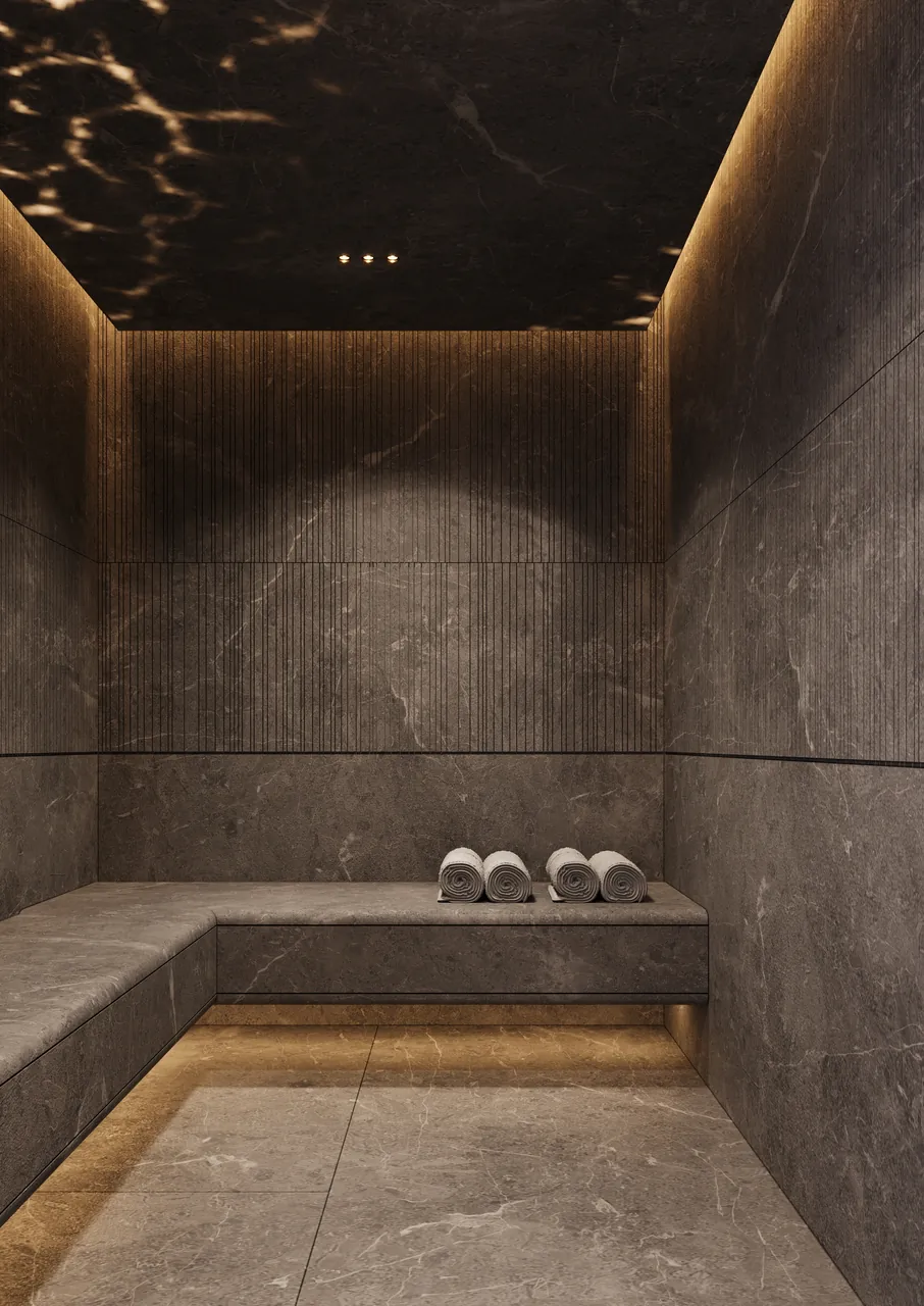 ORLA Infinity Dorchester Collection by Omniyat spa steam room clad in grey stone with fluted panelling built in bench seating and recessed cove lighting in Dubai - Presented by Tohid Fetrat