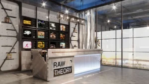 RAW District by Imtiaz in Downtown Jebel Ali creative reception lobby with designer reception desk, digital art display, and contemporary interior design in Dubai - Presented by Tohid Fetrat
