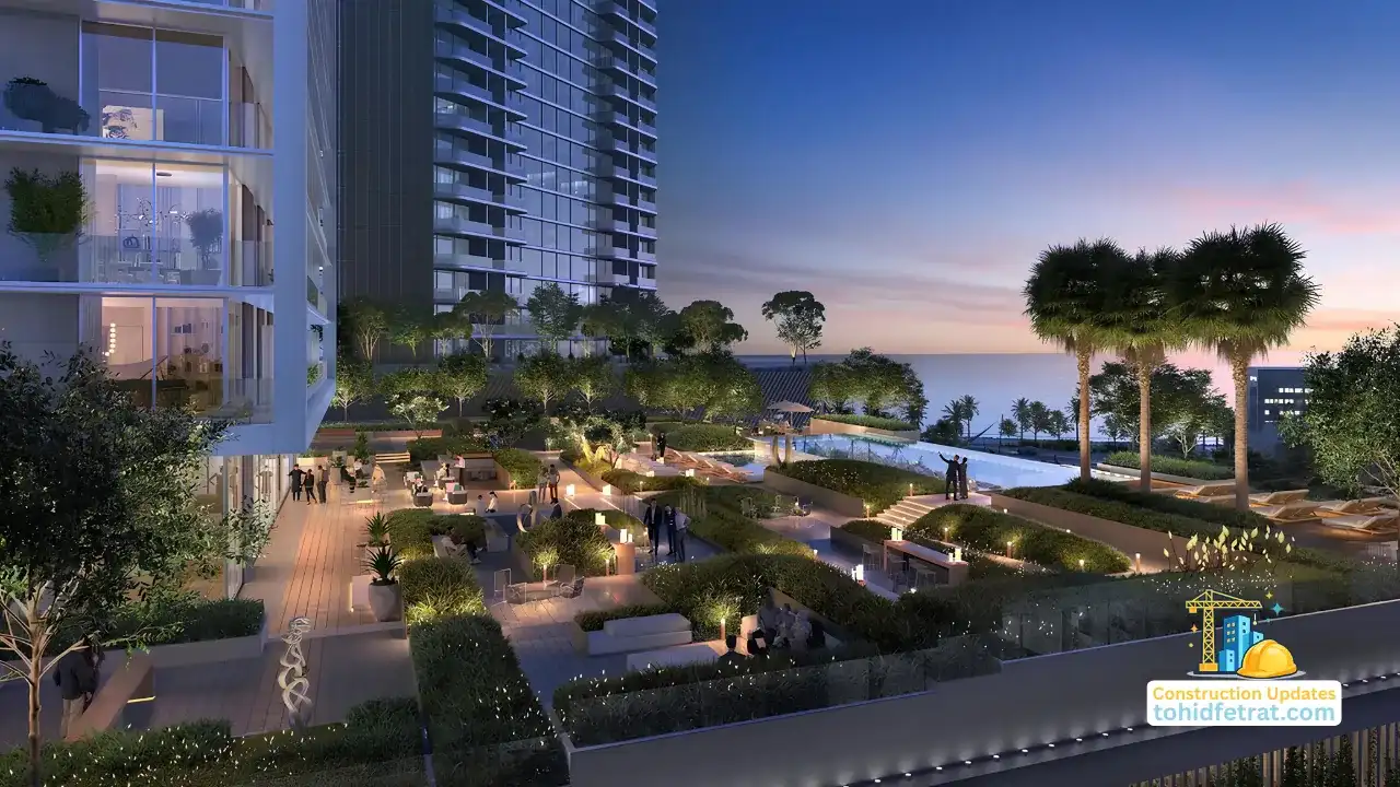 Saria by Beyond in Dubai Maritime City construction update May 2026 showing the landscaped podium terrace pool deck and illuminated tower elevation at dusk in Dubai - Presented by Tohid Fetrat