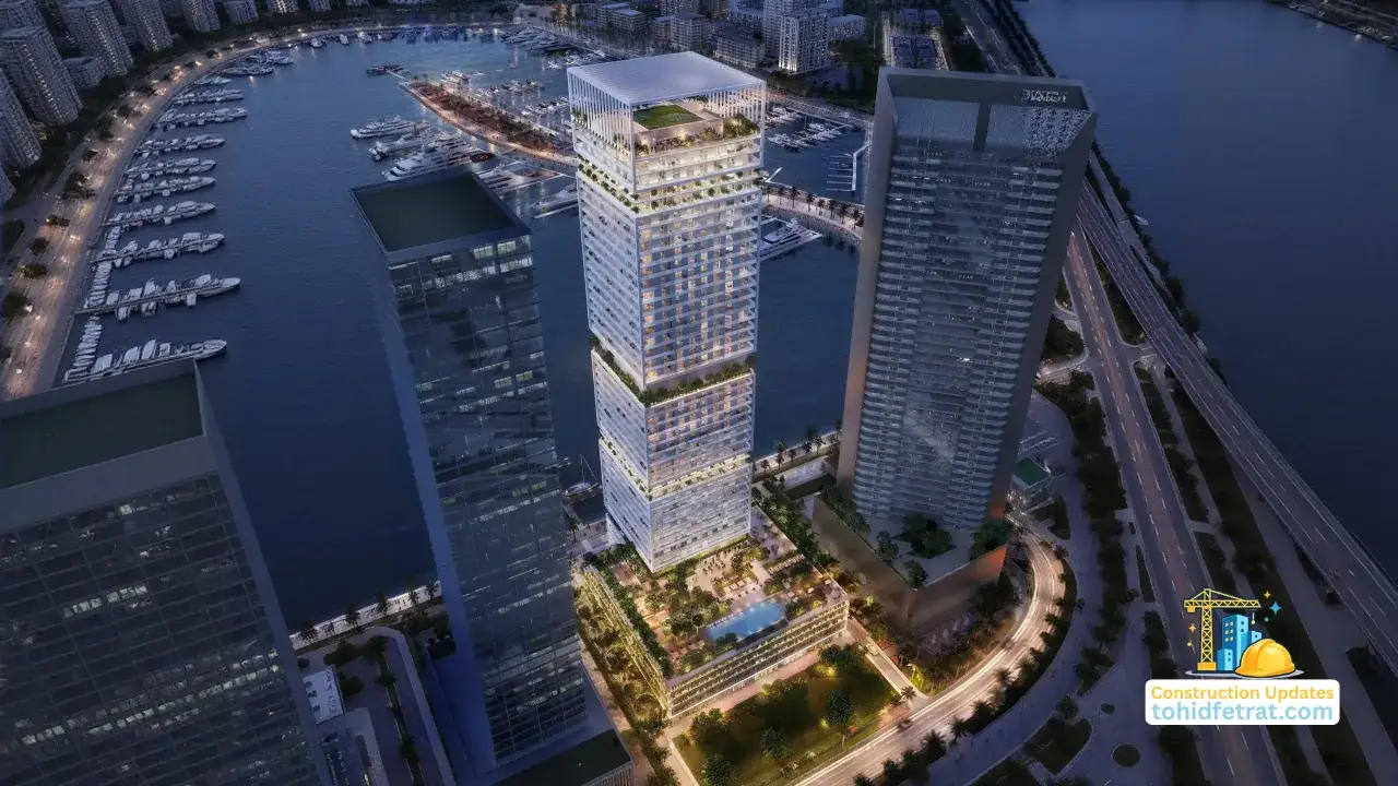 Saria by Beyond in Dubai Maritime City construction updates showing the waterfront tower rising above its podium beside the yacht marina and coastal road network in Dubai Presented by Tohid Fetrat