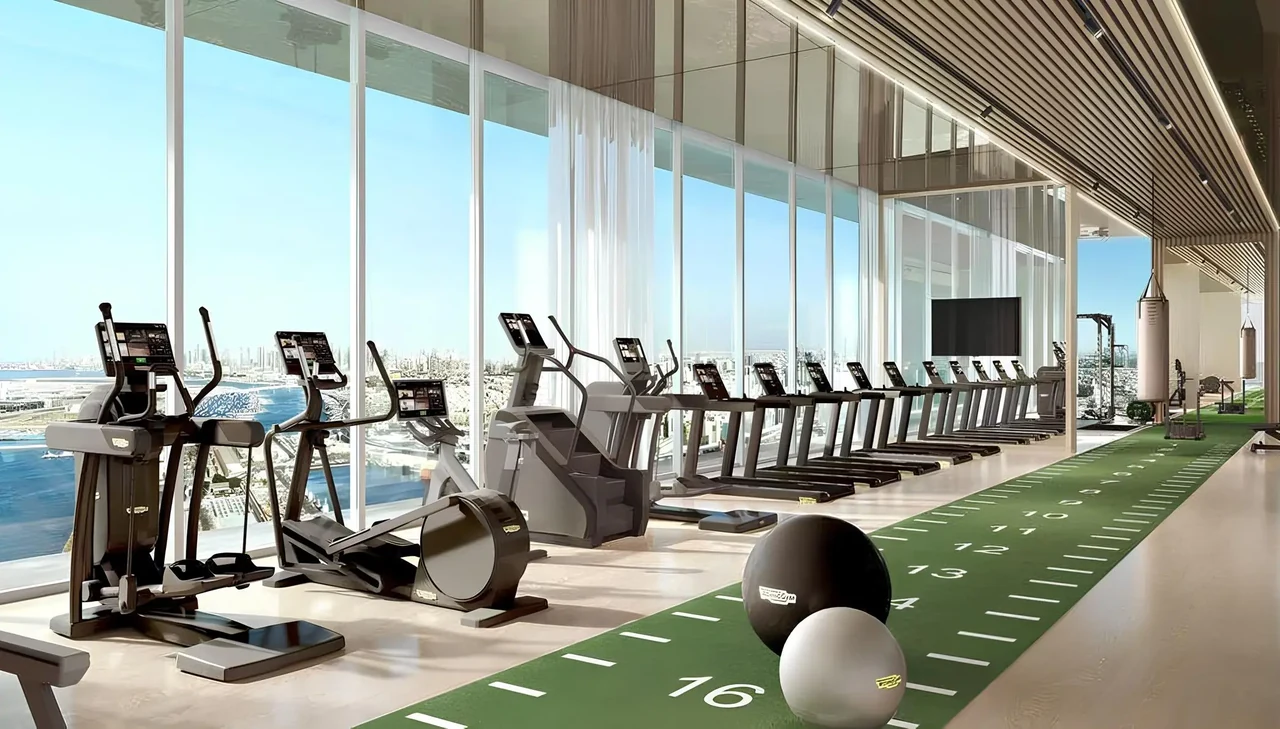 Saria by Beyond in Dubai Maritime City fitness center with cardio equipment an indoor training track and floor to ceiling windows over the water in Dubai - Presented by Tohid Fetrat