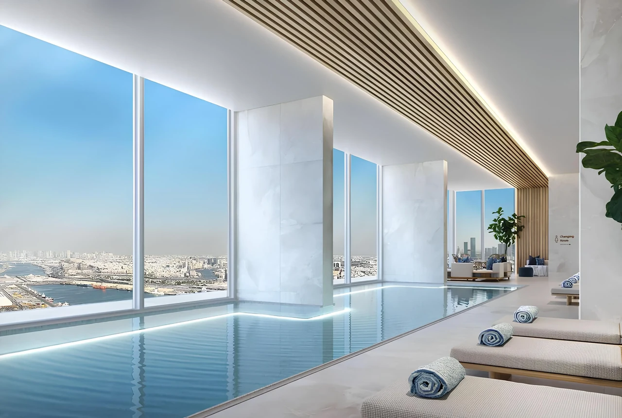 Saria by Beyond in Dubai Maritime City indoor swimming pool with full height glazing marble panelling a timber slat ceiling and elevated views over the water in Dubai - Presented by Tohid Fetrat
