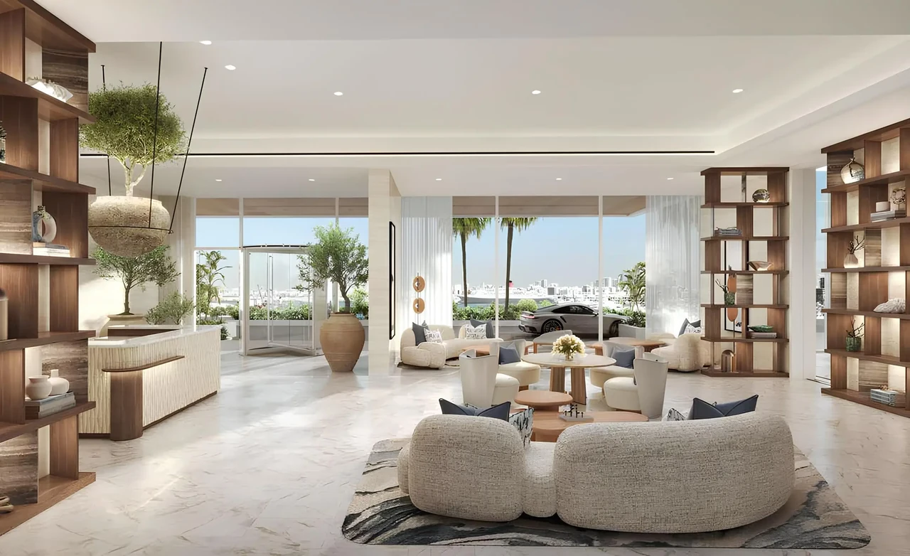 Saria by Beyond in Dubai Maritime City lobby lounge with curved seating open shelving a sculptural olive tree planter and glazing onto the marina in Dubai - Presented by Tohid Fetrat