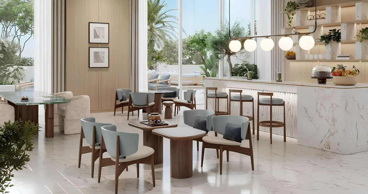 Saria by Beyond in Dubai Maritime City residents cafe with marble counter seating clustered dining tables and glazing onto the landscaped garden in Dubai - Presented by Tohid Fetrat