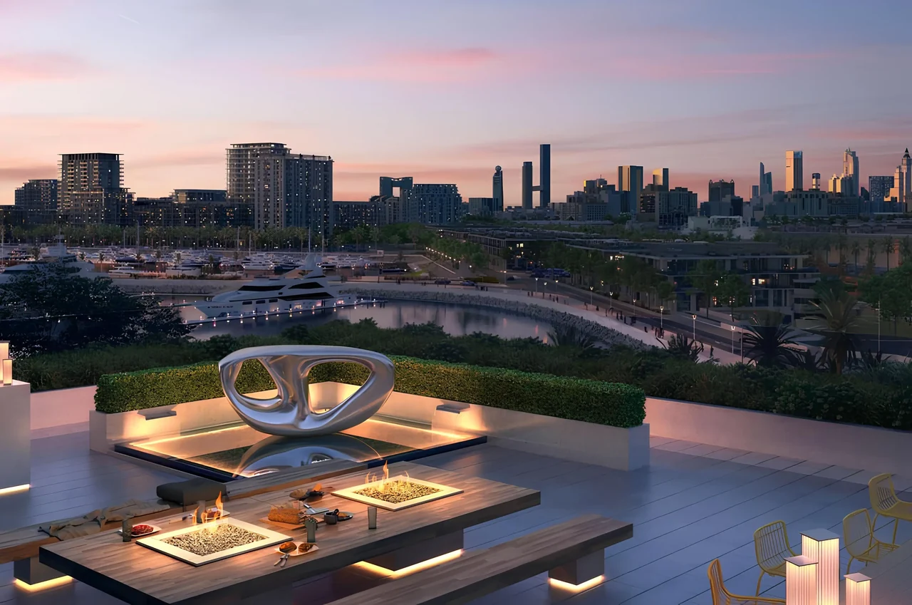 Saria by Beyond in Dubai Maritime City rooftop terrace at sunset with a sculptural centre feature fire tables and hedged seating above the marina in Dubai - Presented by Tohid Fetrat