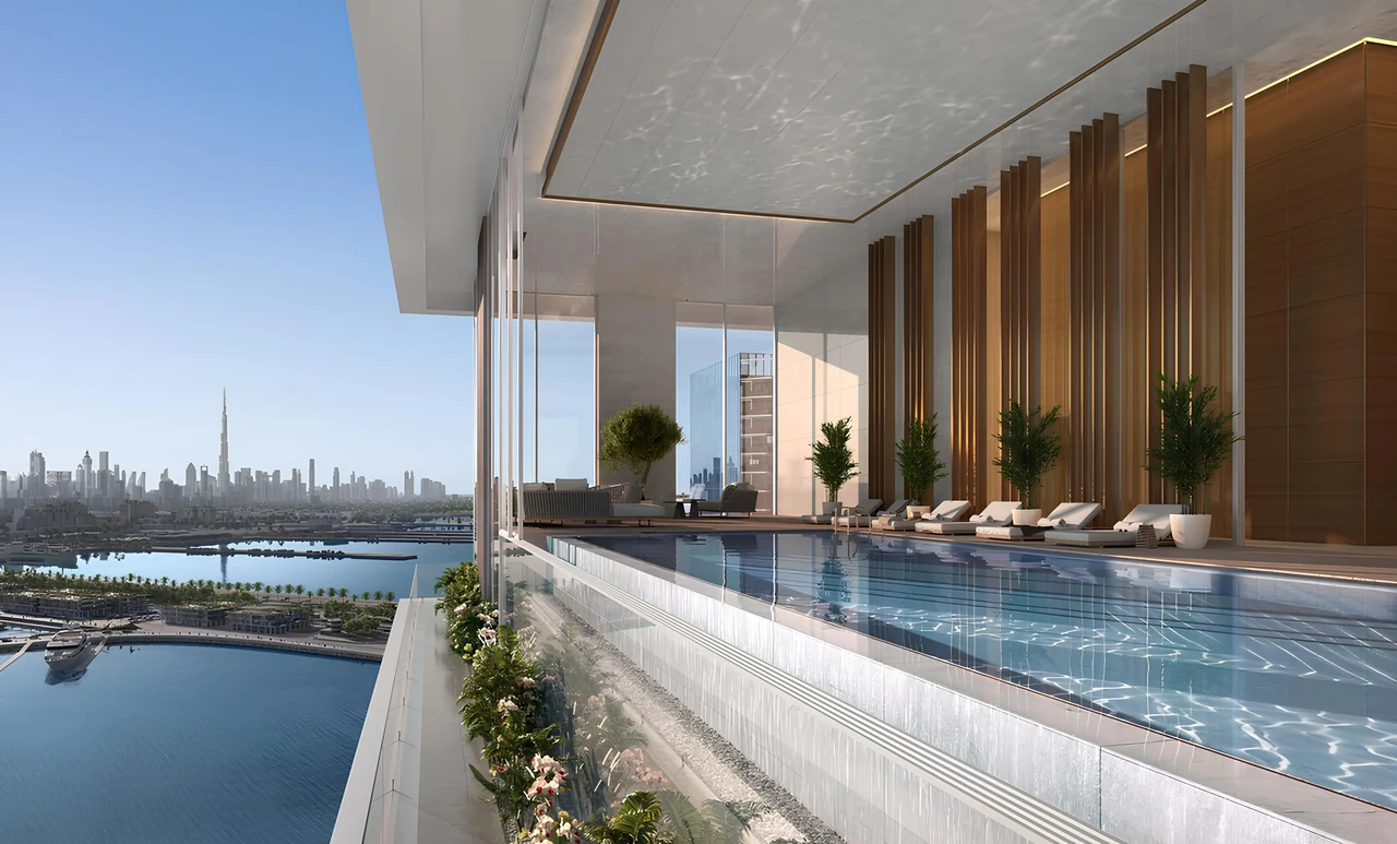Saria by Beyond in Dubai Maritime City sky pool terrace with timber fin screening shaded loungers and wide views across the water to the city skyline in Dubai - Presented by Tohid Fetrat