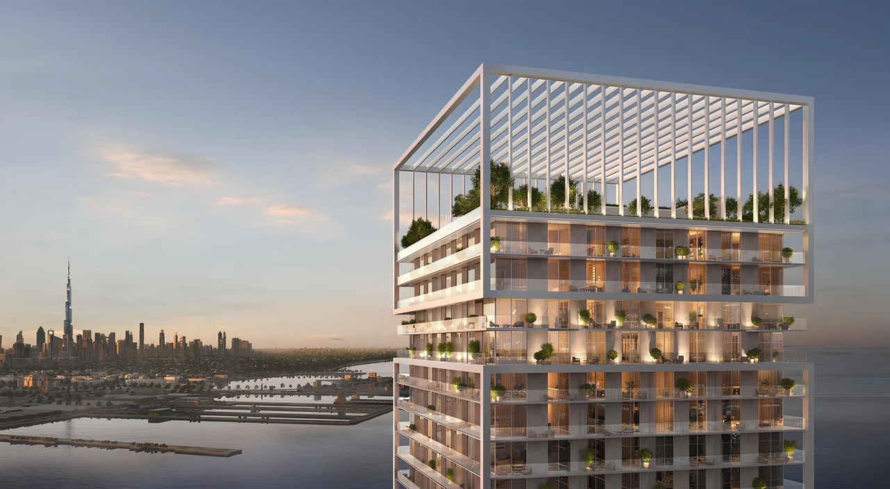 Saria by Beyond in Dubai Maritime City upper tower terraces and pergola crown at golden hour with planted balconies and the distant city skyline in Dubai - Presented by Tohid Fetrat