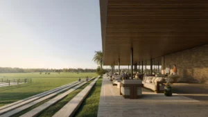 Selvara 4 at Grand Polo Club & Resort by Emaar Properties clubhouse terrace overlooking expansive polo fields with elegant outdoor lounge seating in Dubai. Presented by Tohid Fetrat
