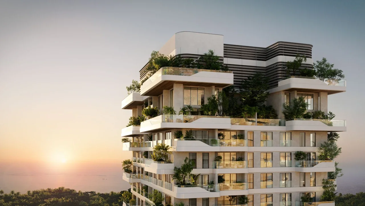 Talea by Beyond in Dubai Maritime City twin waterfront residential towers illuminated at dusk with sea views and marina setting in Dubai Presented by Tohid Fetrat