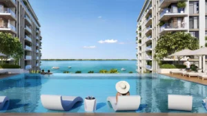 The Cove 2 at Dubai Creek Harbour by Emaar Properties infinity swimming pool overlooking the waterfront between modern residential buildings in Dubai Presented by Tohid Fetrat