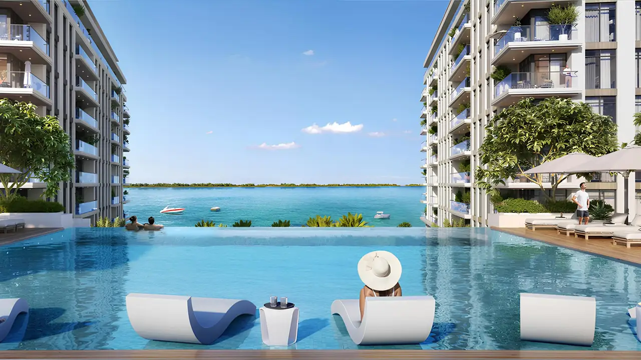 The Cove 2 at Dubai Creek Harbour by Emaar Properties infinity swimming pool overlooking the waterfront between modern residential buildings in Dubai Presented by Tohid Fetrat