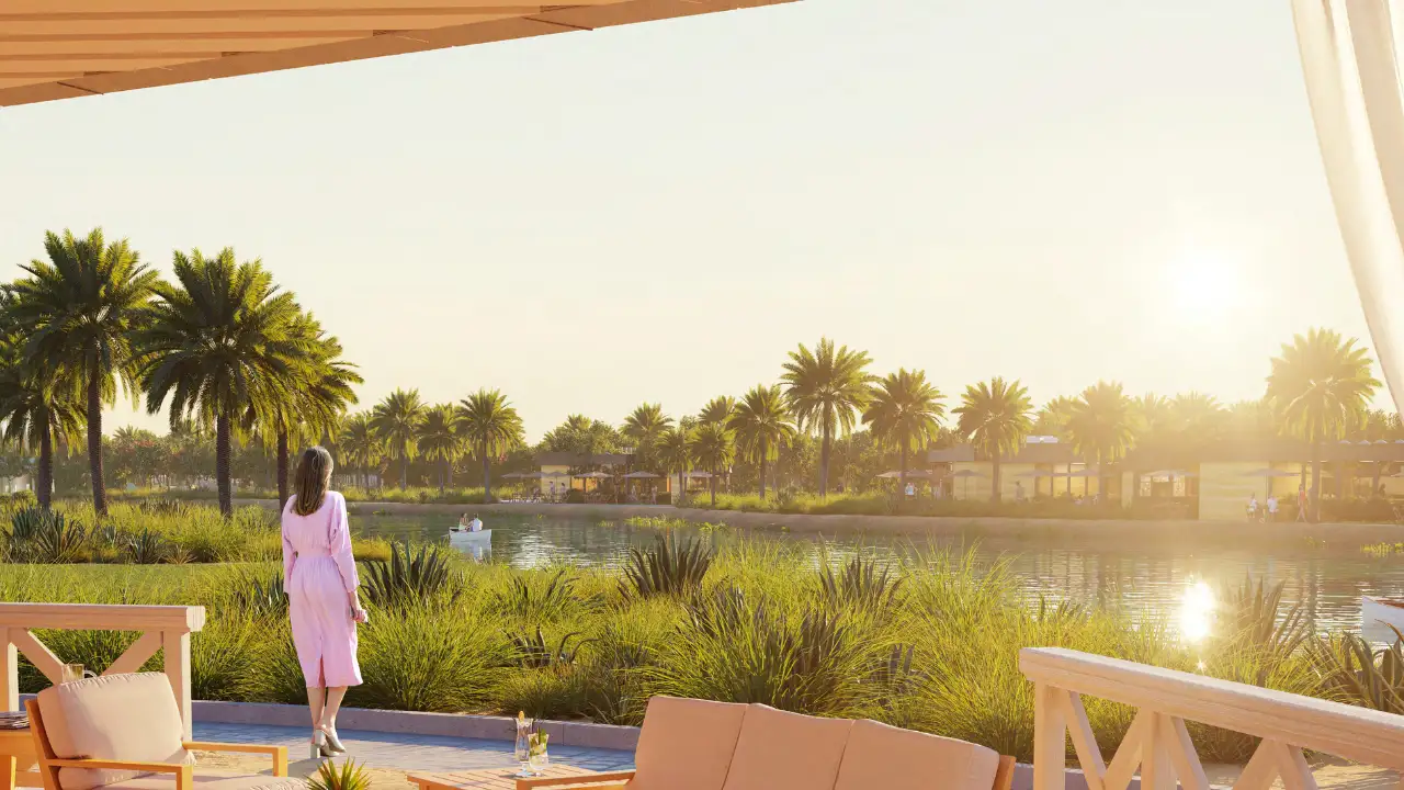 The Farmhouses at DAMAC Hills 2 by DAMAC tranquil lakeside community landscape with lush greenery, palm trees and waterfront leisure spaces in Dubai Presented by Tohid Fetrat